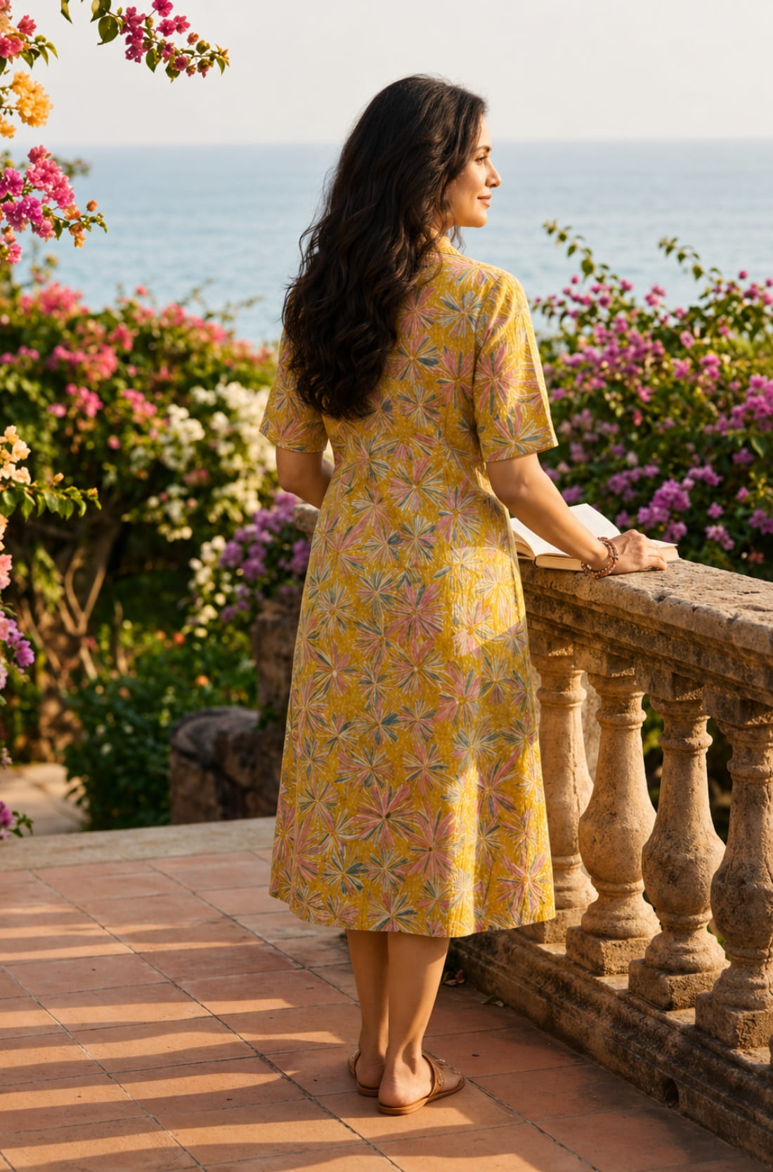 Back view of ochre yellow printed cotton frock style kurti with elbow sleeves and flared silhouette