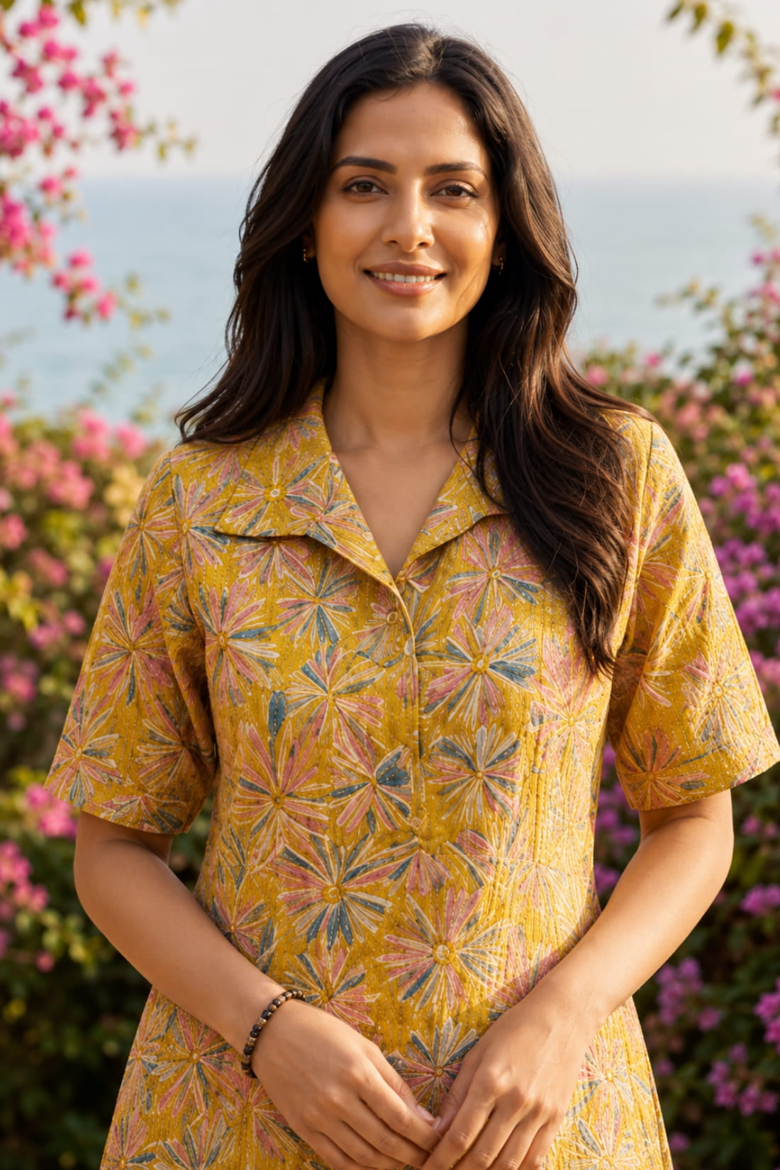 Close-up of ochre yellow printed cotton frock style kurti with collar neck and elbow sleeves