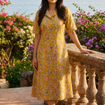Ochre yellow printed cotton frock style kurti with Jaipur floral print, collar neck and flared hem, front view