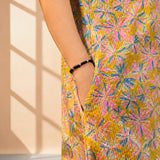 Pocket detail of ochre yellow printed cotton frock style kurti with Jaipur floral print