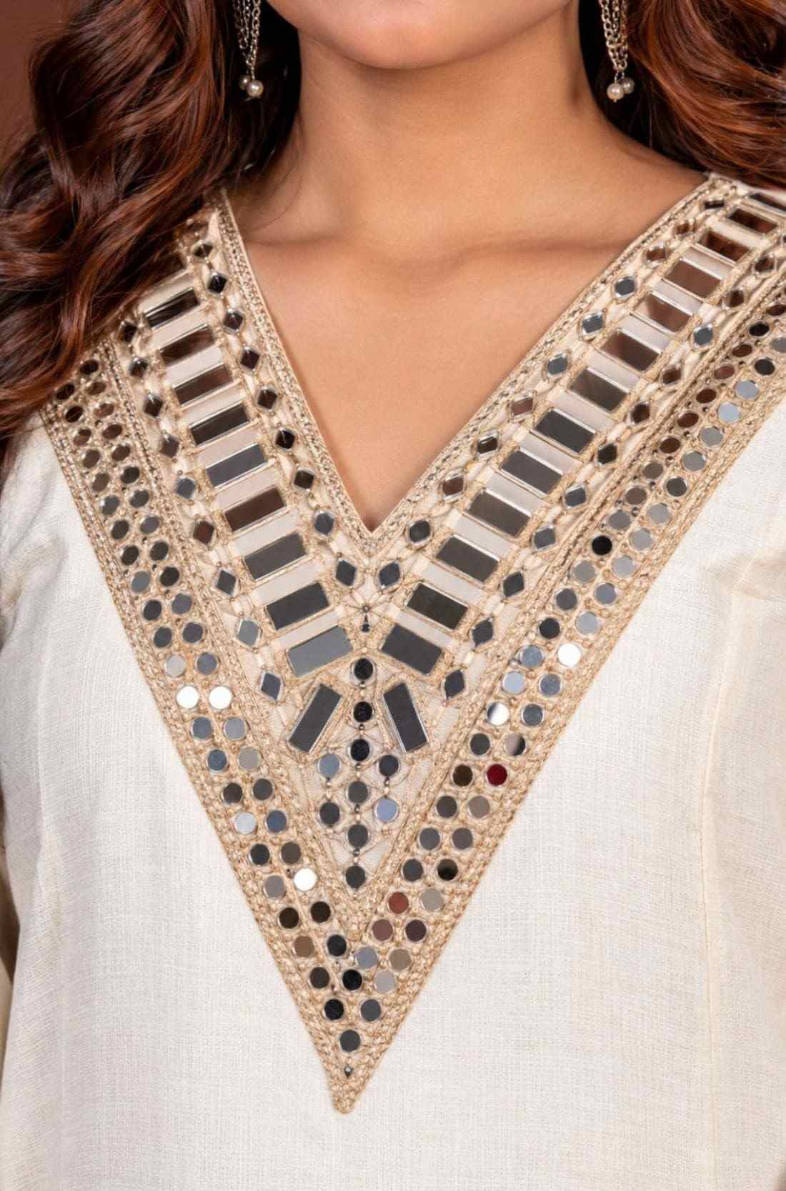 Close-up of mirror work V-neckline on an off-white Anarkali kurta set.