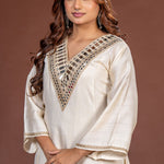 Close-up of broad geometric mirror work on the V-neck off white Vatican Silk kurta
