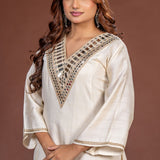 Close-up of broad geometric mirror work on the V-neck off white Vatican Silk kurta