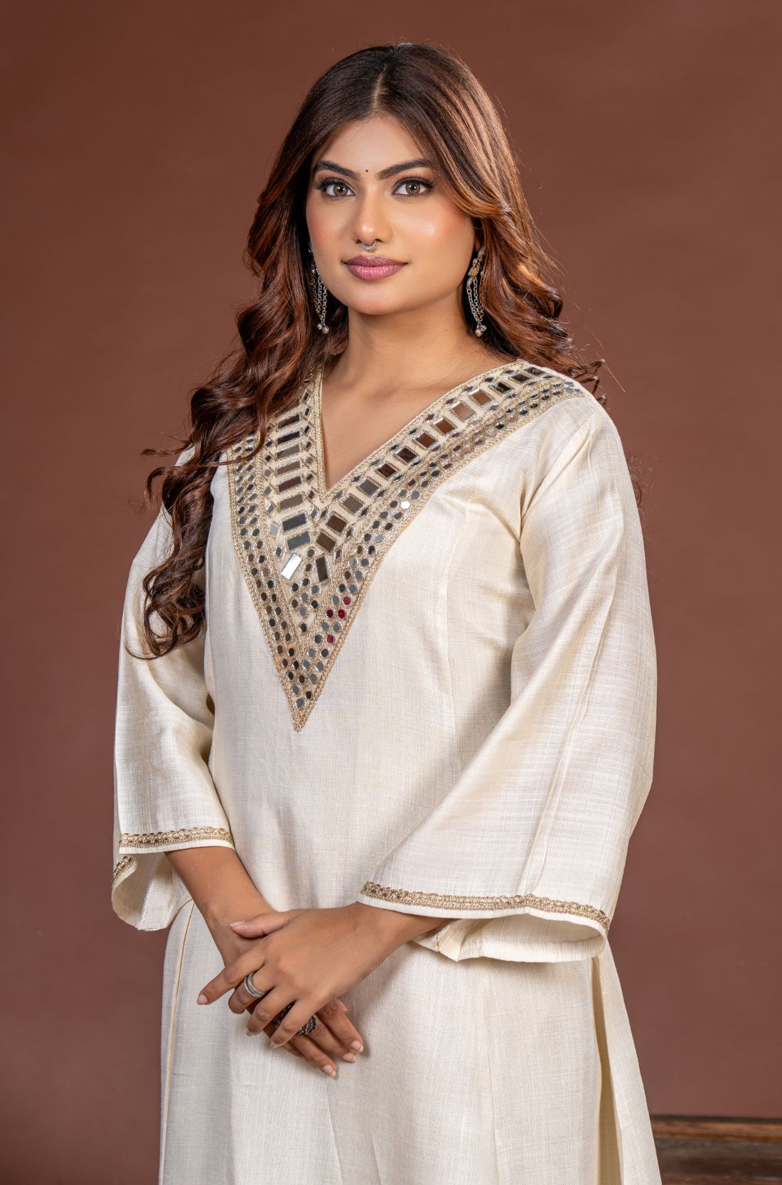 Close-up of broad geometric mirror work on the V-neck off white Vatican Silk kurta