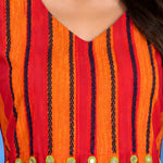 Macro shot of the V-neck and pleated yoke featuring contrast thread embroidery and mirror work accents on the orange handloom cotton midi dress for women.