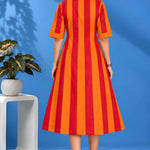 Full back view of the orange striped handloom cotton pintuck embroidered midi dress highlighting the clean tailoring and flared silhouette.