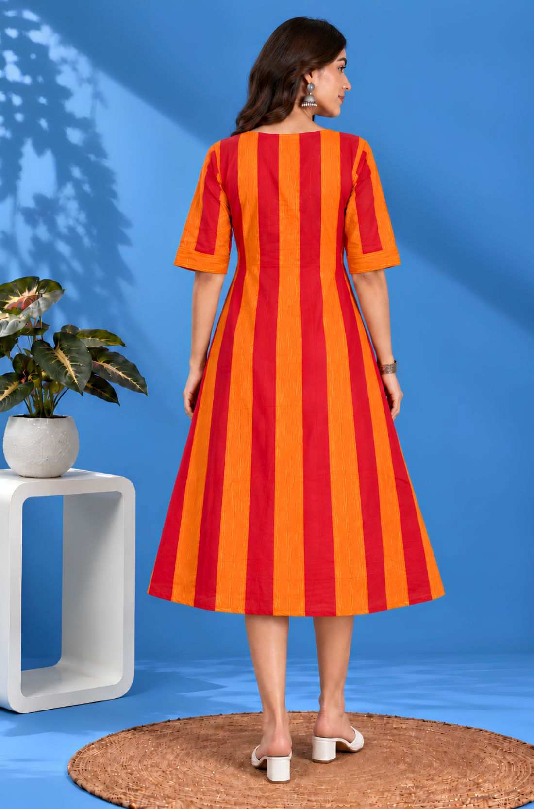 Full back view of the orange striped handloom cotton pintuck embroidered midi dress highlighting the clean tailoring and flared silhouette.
