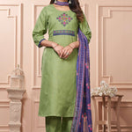 A full length presentation of a pastel green cotton ethnic suit set displaying vibrant floral cross stitch embroidery details along the front panel, styled with straight pants and a printed dupatta