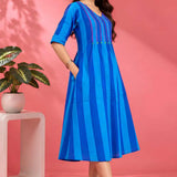 Side profile of a model showcasing the convenient pocket and elegant drape of the Philippine Blue handloom cotton pintuck midi dress.
