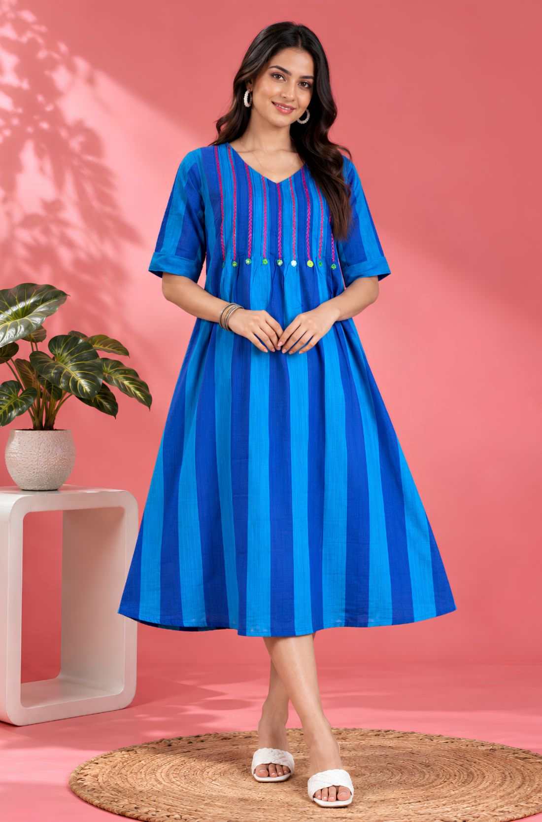 Full front view of a woman wearing a Philippine Blue handloom cotton pintuck embroidered midi dress with elbow sleeves and striped pattern.