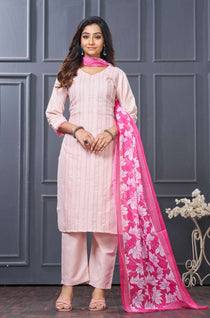 Front full length view of a model wearing a pink pure cotton kurta set featuring vertical pintucks and vibrant multicolor thread embroidery on the neckline, paired with straight trousers and a matching printed dupatta