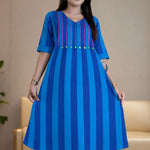 Model holding the hem of the Philippine blue handloom cotton pintucks tunic, showcasing its comfortable A-line flare and elbow-length cuffed sleeves.
