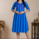 Model wearing a pure handloom cotton pintucks tunic in Philippine blue with vertical stripes and pink embroidered yoke detailing, full-length front view.