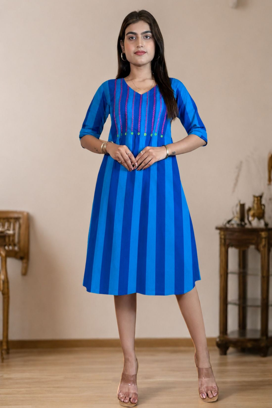 Model wearing a pure handloom cotton pintucks tunic in Philippine blue with vertical stripes and pink embroidered yoke detailing, full-length front view.