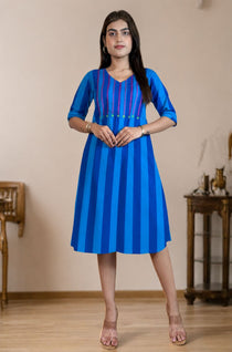 Model wearing a pure handloom cotton pintucks tunic in Philippine blue with vertical stripes and pink embroidered yoke detailing, full-length front view.
