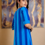 Model looking over her shoulder showing the back and side profile of the Philippine blue striped pure handloom cotton tunic dress.