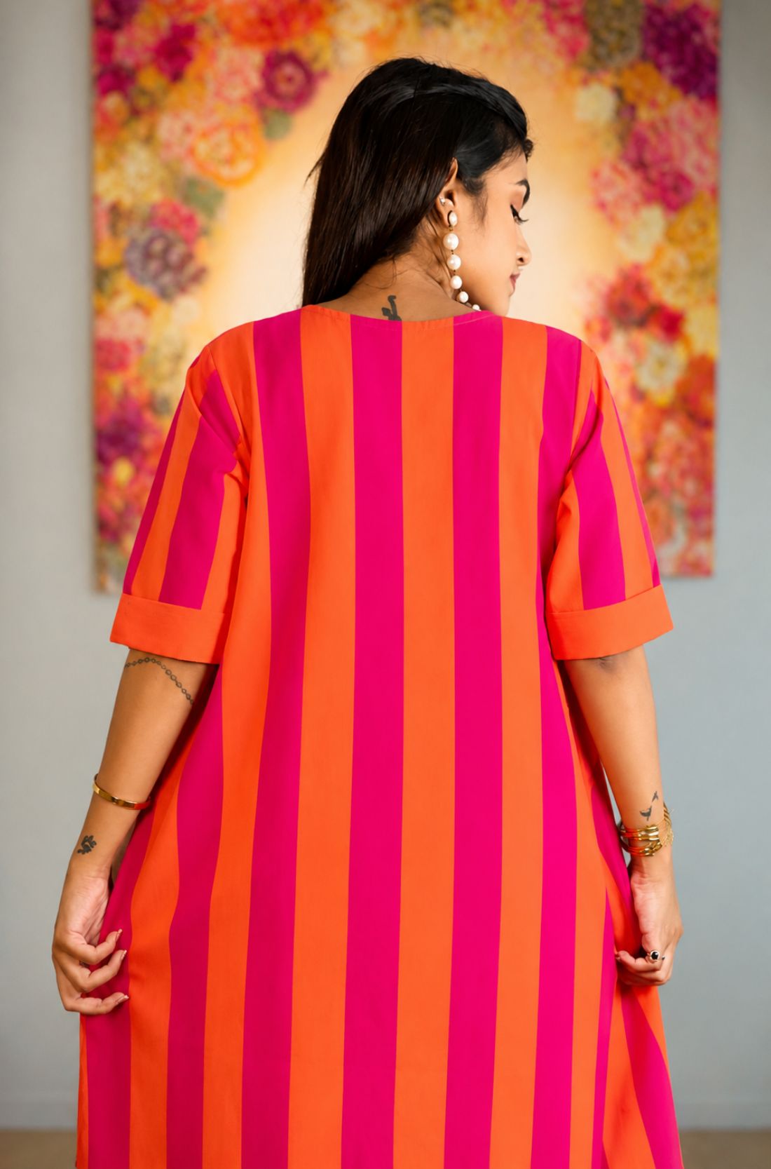 Back view of the pink piano pure handloom cotton tunic highlighting the vertical striped pattern and comfortable loose fit.