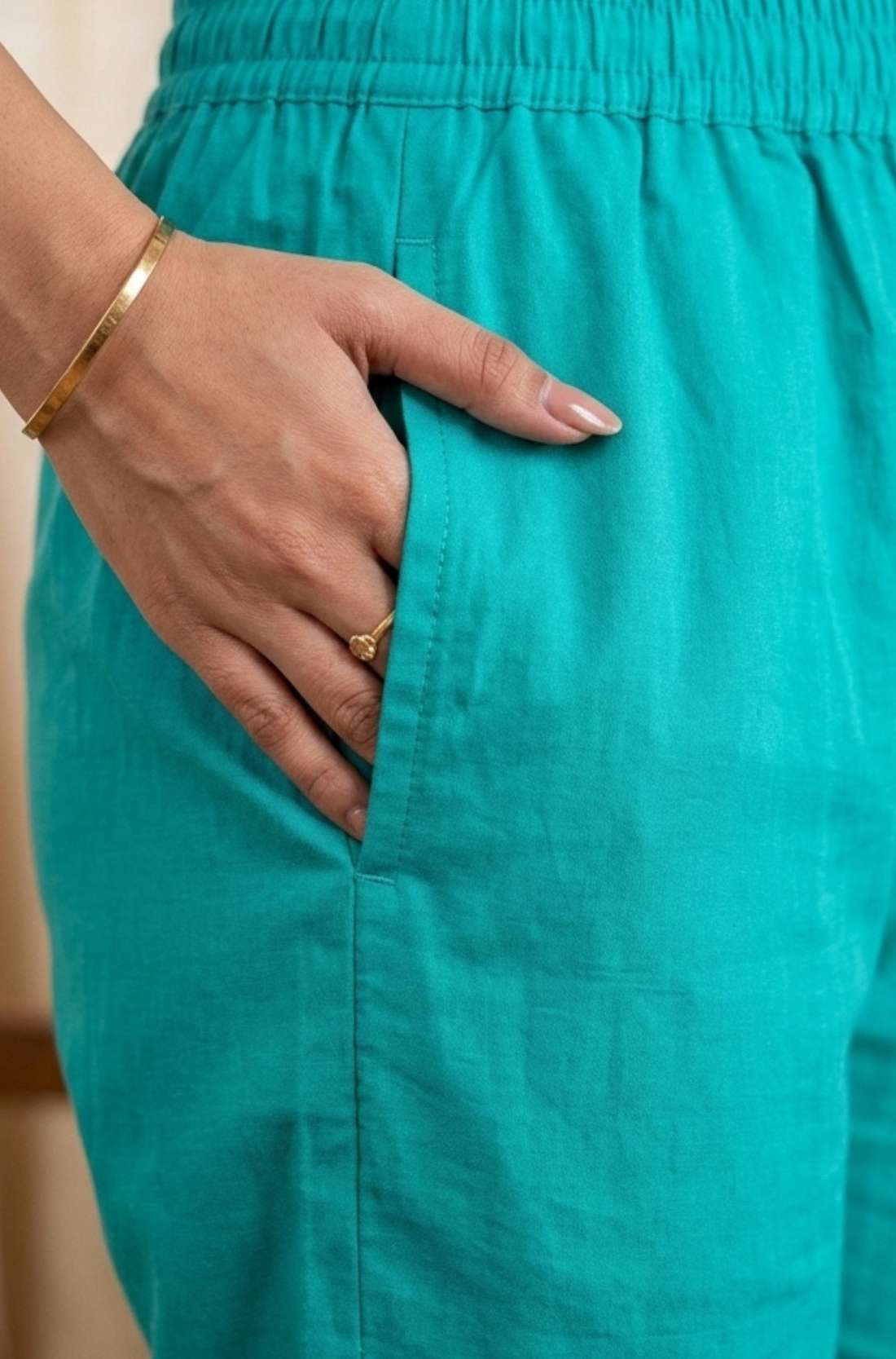 Close-up view highlighting the functional side utility pocket tailored seamlessly into the rama green straight kurta, showing a hand resting inside the pocket.