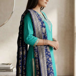 Side profile view of a woman wearing a rama green ethnic embroidered suit showcasing the sleeve details and straight cut pants