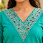 Close-up of intricate thread and sequin embroidery on the scalloped V-neckline of a Rama Green cotton kurta