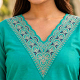 Close-up of intricate thread and sequin embroidery on the scalloped V-neckline of a Rama Green cotton kurta
