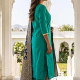Side profile of woman wearing Rama Green straight kurta and trouser set with tasselled Banarasi silk dupatta