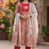 Front full length view of a model in a premium red pashmina silk printed kurta set featuring elegant circle motif patterns, paired with straight trousers and a matching printed dupatta.
