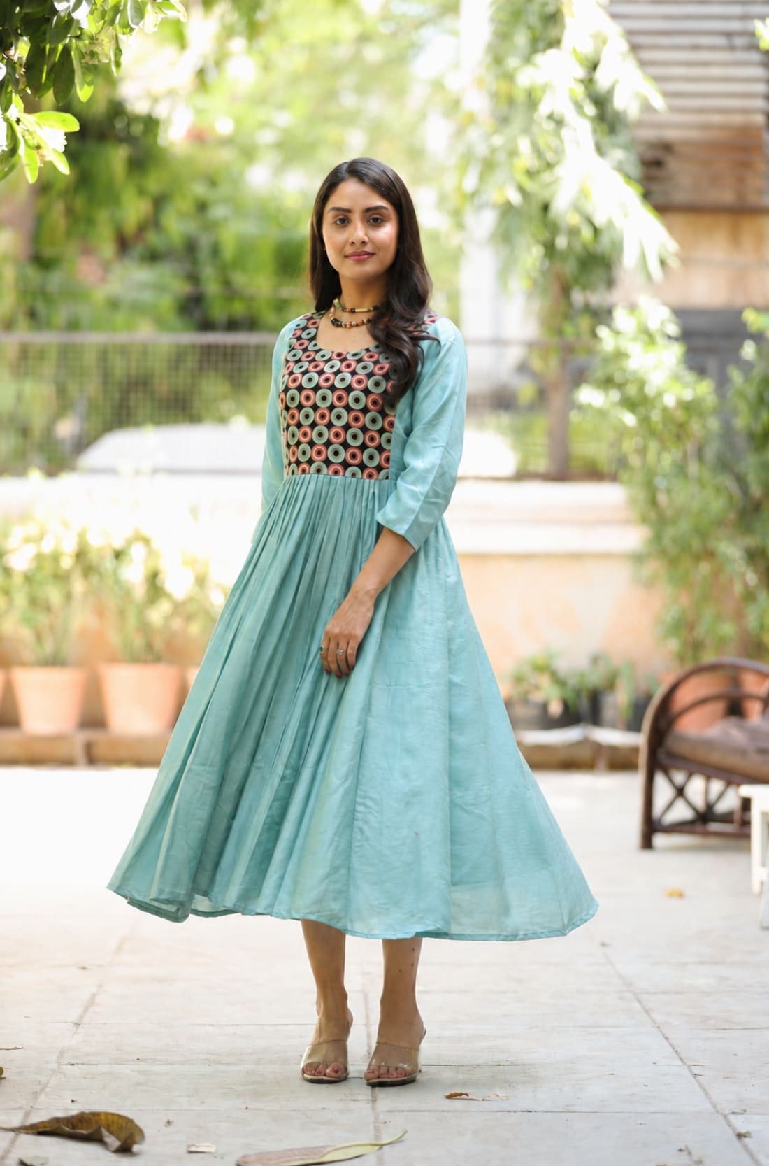 Sea green flared kurti showing A-line silhouette, gathered waist and flared hem