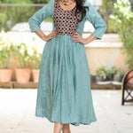 Sea green aari embroidery flared kurti with 3/4 sleeves and contrast black yoke, front view