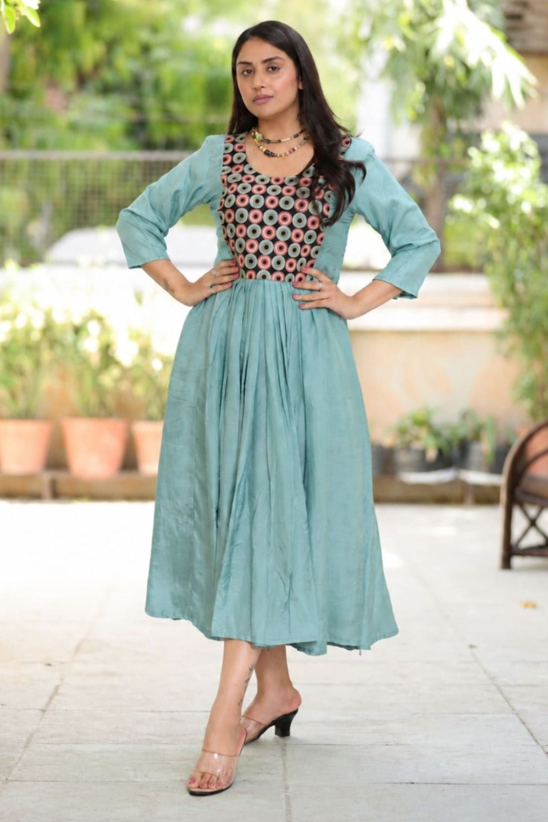 Sea green aari embroidery flared kurti with 3/4 sleeves and contrast black yoke, front view