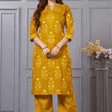 Front full length view of a model wearing an ochre yellow straight fit floral print cotton kurta set with coordinating chevron pants and a printed dupatta