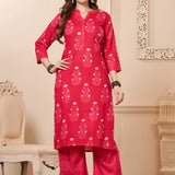 Front full length view of a model wearing a rani pink straight fit floral print cotton kurta set with matching chevron pants and a printed dupatta