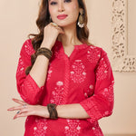 Close up view of the V neckline design showcasing delicate white lace inserts and border details on the rani pink floral printed cotton kurta
