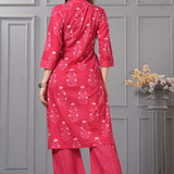 Back view of the rani pink straight fit floral cotton kurta set highlighting the print continuation and the dupatta drape