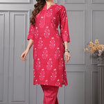 Side profile view of a model in the rani pink floral printed cotton ethnic suit showcasing the clean straight-cut drape and chevron print trousers