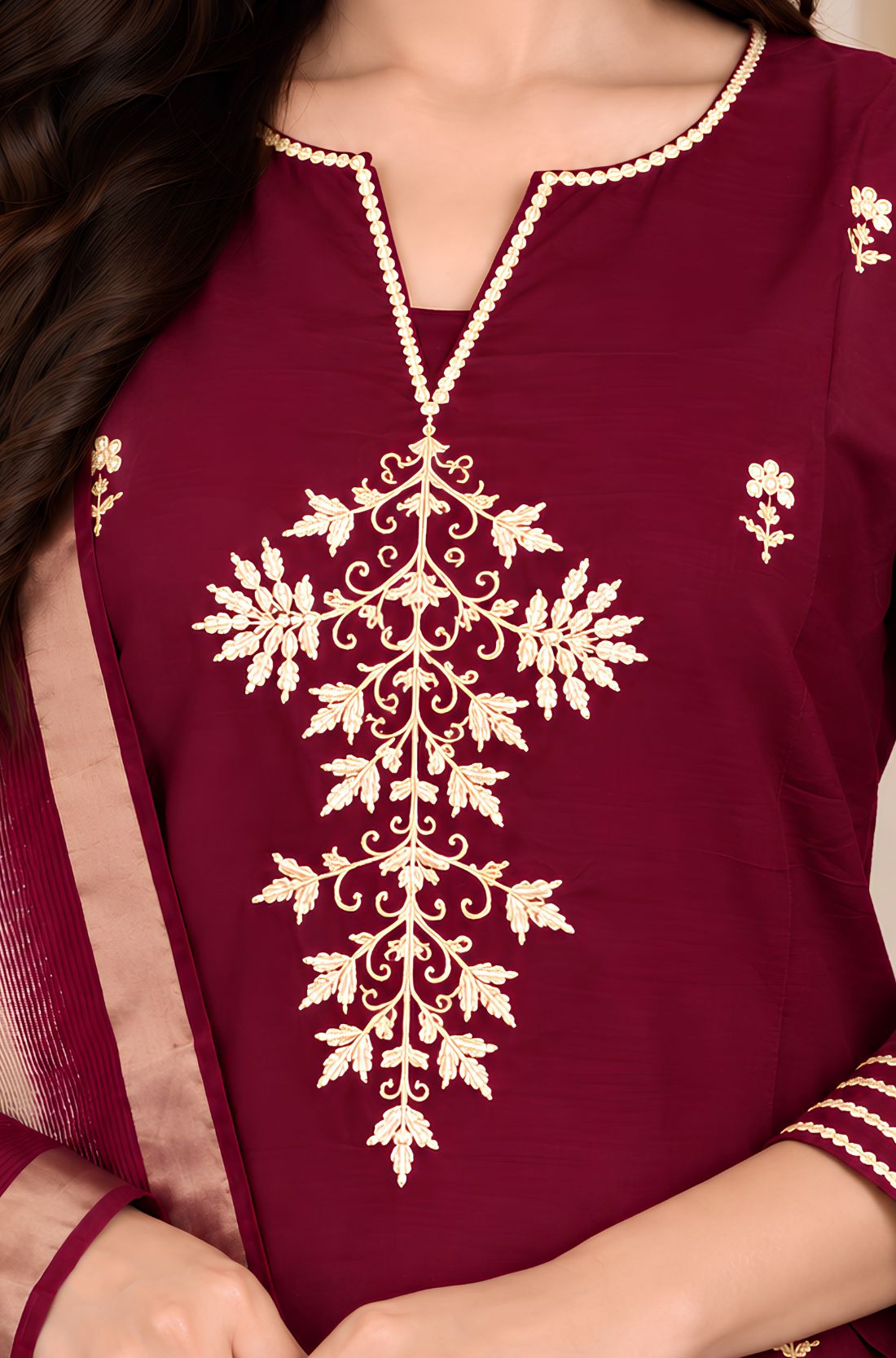 Close-up of golden Aari embroidery and V-cut neckline on wine silk blend kurta for women
