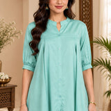 Close-up shot showing the collar, front button placket, and pleated details of the light sea green rayon top.