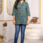 Women's Geometric Hand Block Print Pure Cotton Shirt Style Kurti in blue and olive green featuring a stand collar, wooden button placket, 3/4 sleeves, and a relaxed hip-covering silhouette paired with blue jeans.