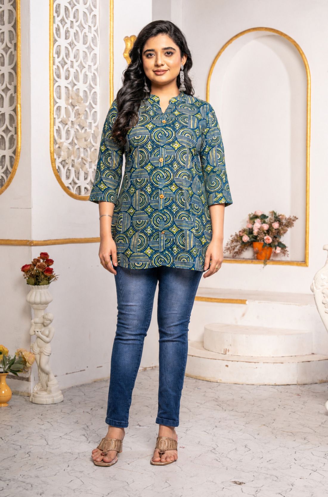 Women's Geometric Hand Block Print Pure Cotton Shirt Style Kurti in blue and olive green featuring a stand collar, wooden button placket, 3/4 sleeves, and a relaxed hip-covering silhouette paired with blue jeans.