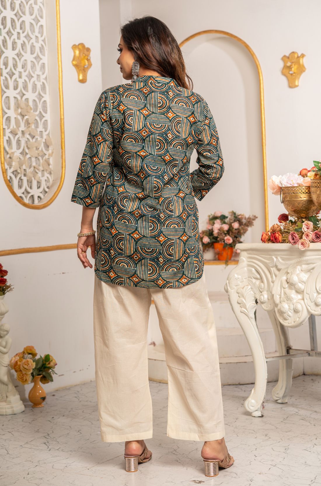 Back view of Women's Geometric Hand Block Print Pure Cotton Shirt Style Kurti in forest green and rust orange displaying an all-over handcrafted geometric block print and hip-covering silhouette.