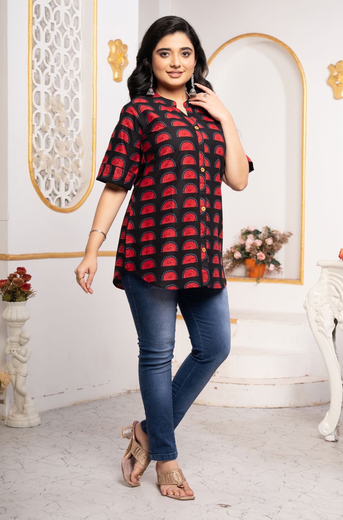 Women's Geometric Hand Block Print Pure Cotton Shirt Style Kurti in black and red featuring a stand collar, wooden button placket, 3/4 sleeves, and a relaxed hip-covering fit paired with blue jeans.