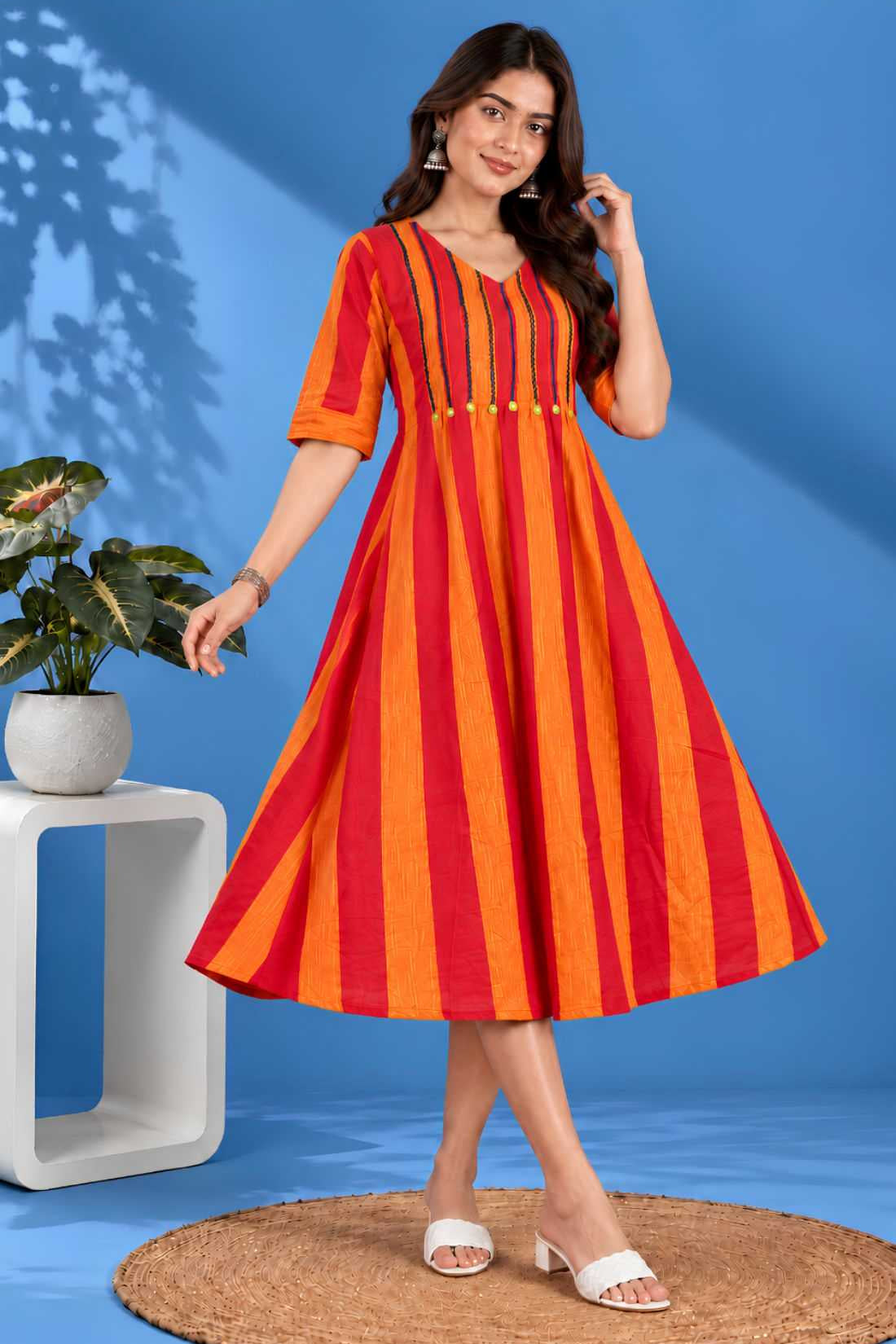 Front angle view showcasing the flared hem and striped pattern of the orange handloom cotton tunic frock for casual and work wear.