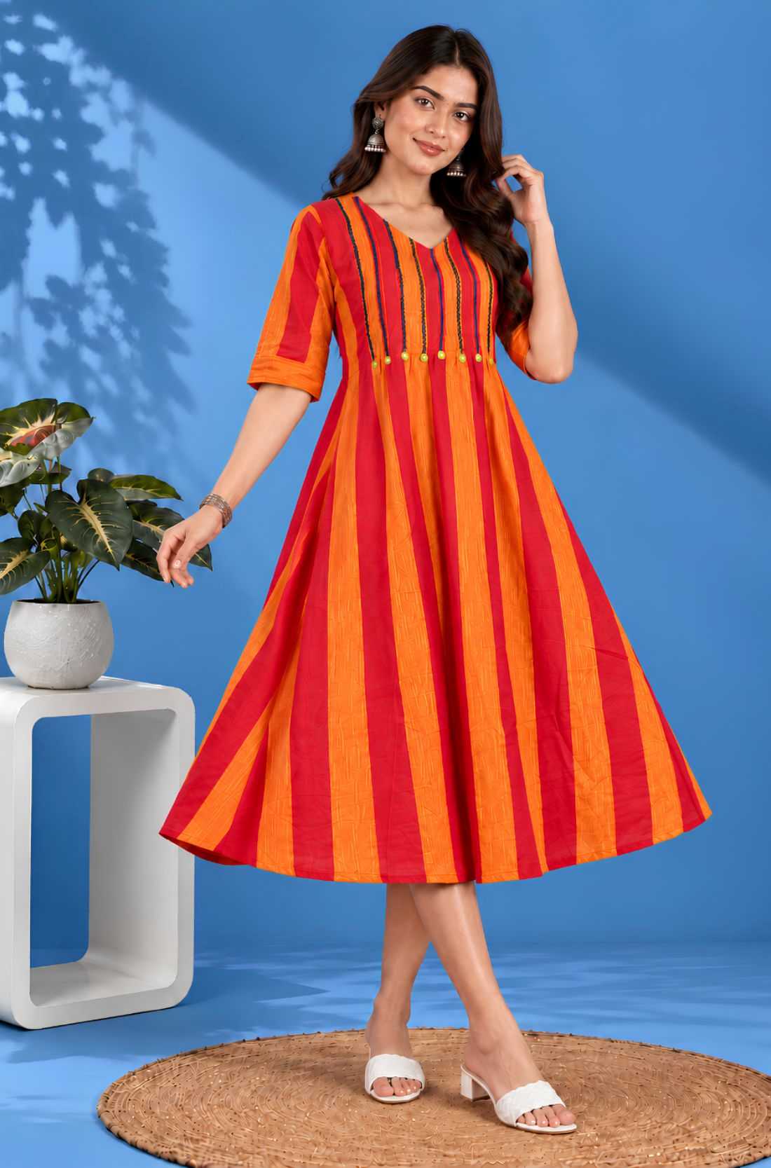 Front angle view showcasing the flared hem and striped pattern of the orange handloom cotton tunic frock for casual and work wear.