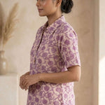 Side profile of a women's blush pink floral block print cotton shirt with relaxed fit and classic collar.