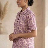 Side profile of a women's blush pink floral block print cotton shirt with relaxed fit and classic collar.