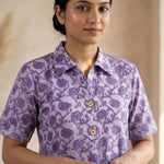 Front close-up of a women's lavender floral hand block print cotton shirt with wooden buttons and classic collar.