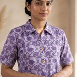 Front close-up of a women's lavender floral hand block print cotton shirt with wooden buttons and classic collar.