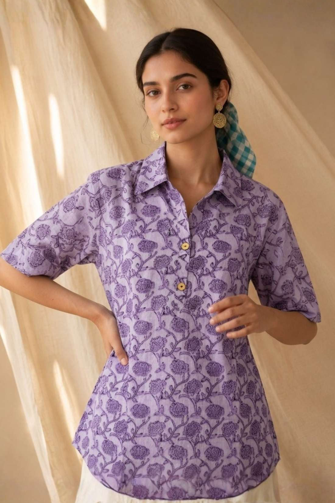 Front close-up of a women's lavender floral hand block print cotton shirt with wooden buttons and classic collar.