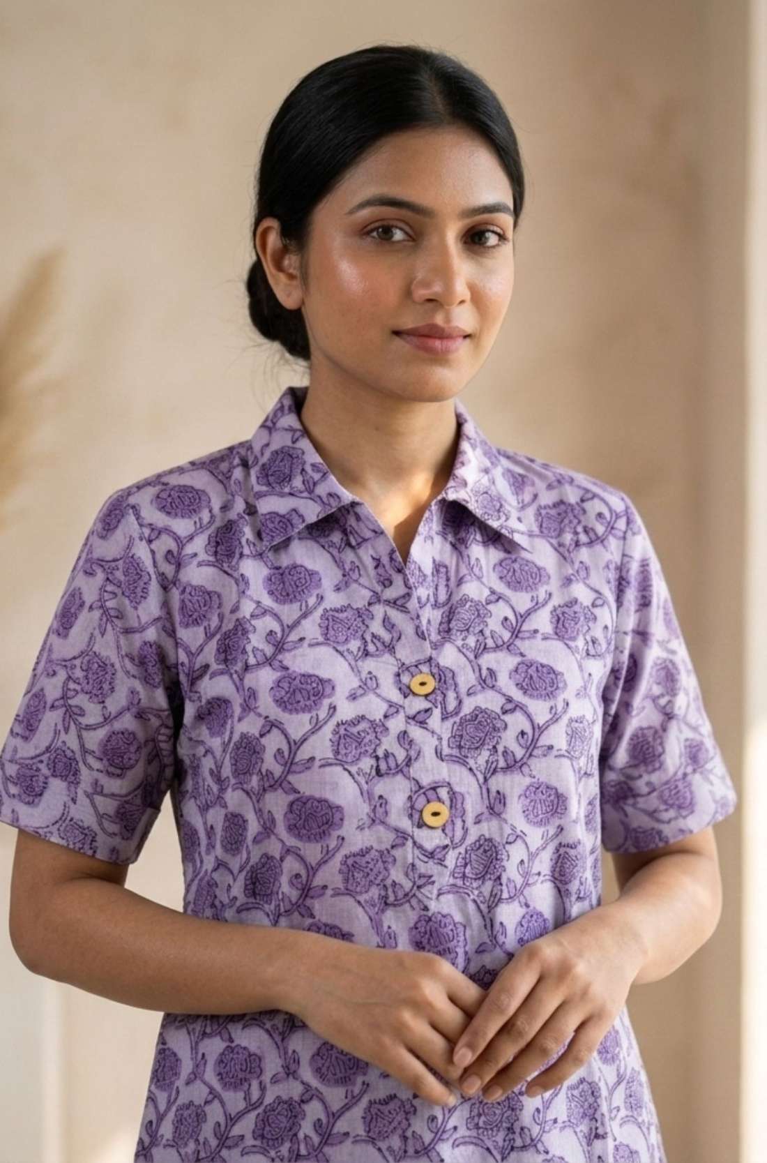 Front close-up of a women's lavender floral hand block print cotton shirt with wooden buttons and classic collar.