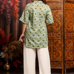 Back View
Back view of a women's mint green block print cotton short kurti featuring short sleeves and curved hem.
